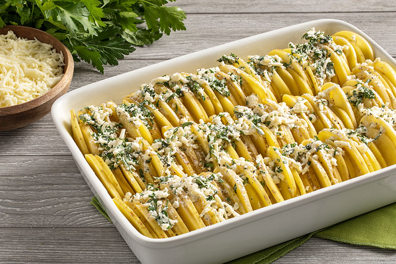 Arrange the potato slices vertically and tightly in the prepared baking dish. Pour any leftover cream mixture over the potatoes.