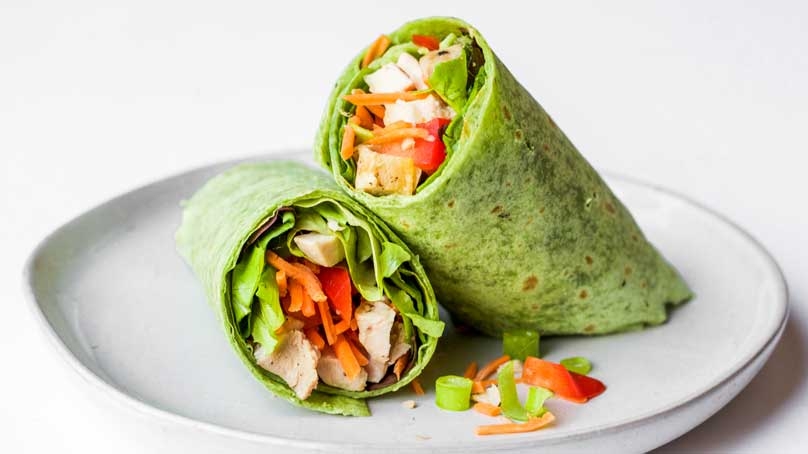 Looking for easy wrap ideas for summer? This one looks like a rainbow with colorful veggies. Learn how to make Thai chicken wraps in 15-minutes or less!