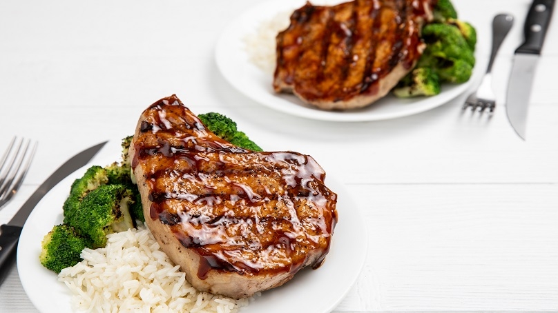 Honey Garlic Grilled Pork Chops on plate with Broccoli and White Rice, Silverware - Knife and Fork