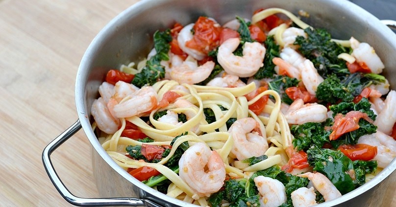 Garlic Butter Shrimp, fettucccine, kale, to,atoes, stainless stel pot, wood countertop