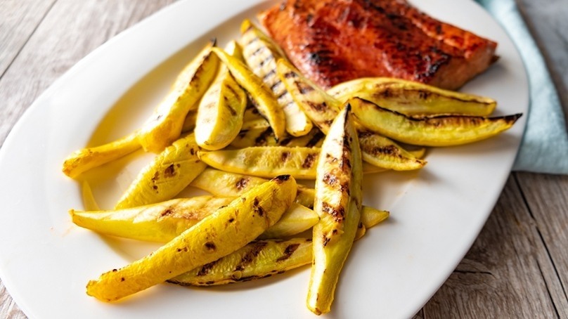 Grilled Summer Squash wiht Salmon on white plate