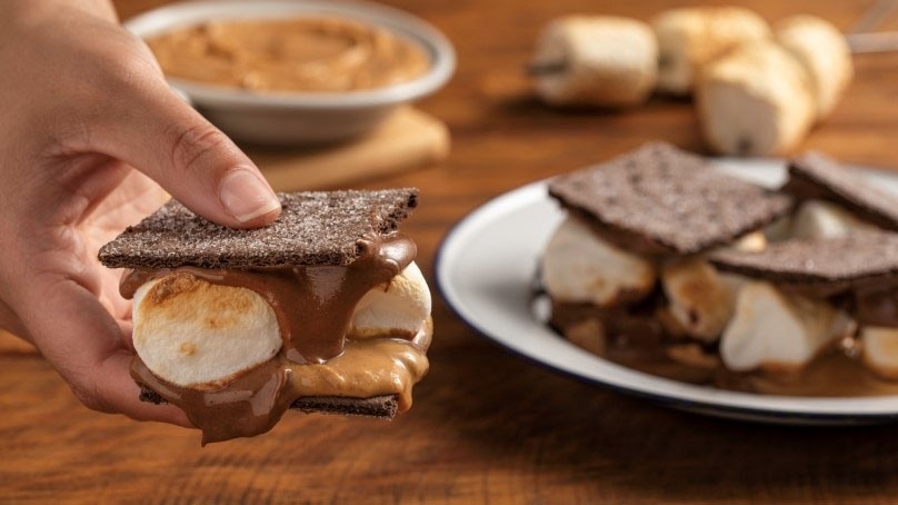 Hand holding Easy Peanut Butter S’mores, plated sS'mores, marshmallows, peanut butter