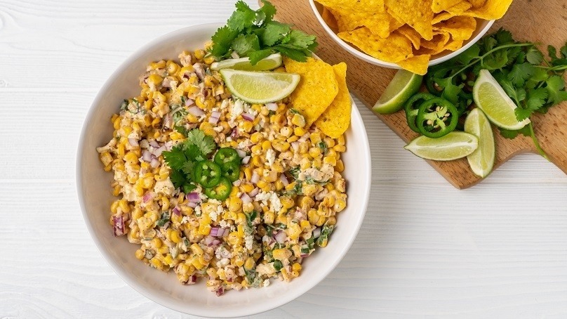Mexican Street Corn Dip, bowl, cilantro, lime wedges