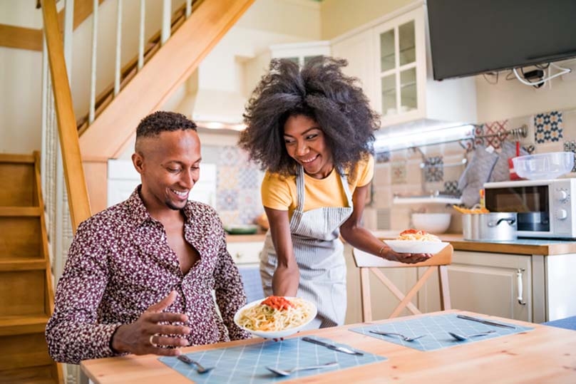 Young couple sharing a valentine's meal, kitchen table