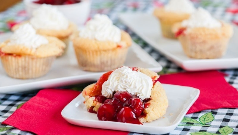Shareable Mini Cherry Pies on white plate with red napkin