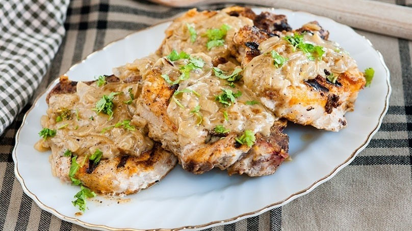 Grilled Smothered Pork Chops on white plate