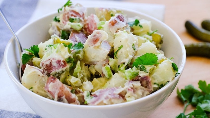 Dill Pickle Potato Salad in white bowl on counter top