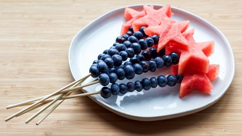 Watermelon & Blueberry Skewers on white plate, wood table