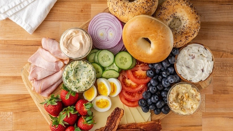 Bagel Board,bagels, cream cheese fruit vegetables, strawberries, blueberries, tomato slices, cucumber slices, red onion, deli meat