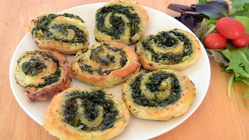Spinach Cheese Puff Pastry Swirls, plate, wood table, garnishes