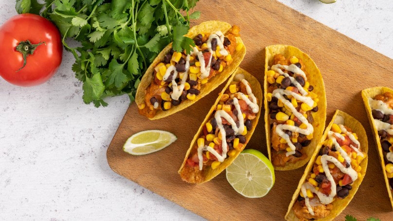  Easy Chicken Tacos, tomato, cilantro, lime wedges, wood cutting board, stone countertop