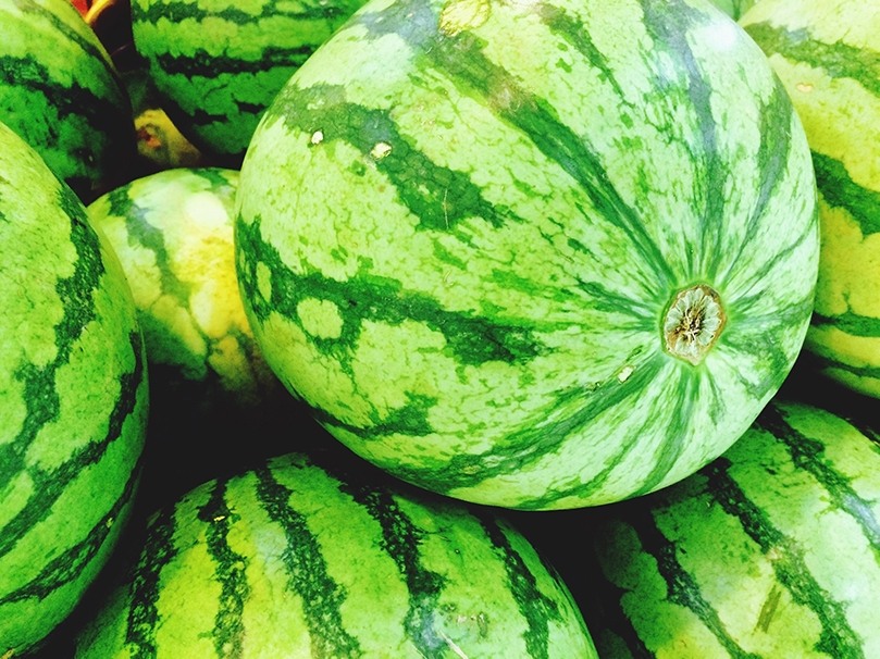 Closeup of stack of bright green, fresh watermelon