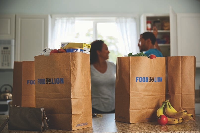 Couple at home with Food Lion grocery bags